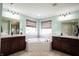 Main bathroom with dual vanities, mirrors and a jacuzzi tub between them at 10291 Normandy Way, Fishers, IN 46040