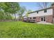 Expansive backyard featuring a deck, grassy lawn and a charming home exterior at 10429 Lasalle Rd, Carmel, IN 46033