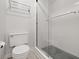 This bright bathroom features a new shower, toilet, towel rack, and bright natural light at 10429 Lasalle Rd, Carmel, IN 46033