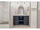 Bathroom features a modern vanity, stylish mirror and lighting, a walk-in shower, and plenty of storage at 10429 Lasalle Rd, Carmel, IN 46033