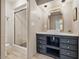 Bathroom features a modern vanity, stylish mirror and lighting, a walk-in shower, and tile flooring at 10429 Lasalle Rd, Carmel, IN 46033