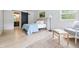 Tastefully decorated bedroom features an ensuite bathroom with a sliding barn door and a comfy sitting area at 10429 Lasalle Rd, Carmel, IN 46033