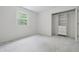 Neat bedroom features a closet with built-in shelving, neutral carpet, and a sunny window at 10429 Lasalle Rd, Carmel, IN 46033