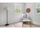 Bedroom sitting area featuring a comfy chair, an ottoman and bright, natural lighting from two windows at 10429 Lasalle Rd, Carmel, IN 46033