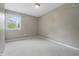 Cozy bedroom featuring neutral carpeting, grey walls and a window bringing in natural light at 10429 Lasalle Rd, Carmel, IN 46033