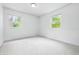 Bright bedroom with two windows, neutral carpet, white walls, and plenty of natural light at 10429 Lasalle Rd, Carmel, IN 46033