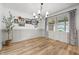 Dining room with hanging light fixture, wood floors, and a large window for natural light at 10429 Lasalle Rd, Carmel, IN 46033