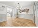 Open dining room features wood floors and access to a modern, white kitchen at 10429 Lasalle Rd, Carmel, IN 46033