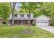 Charming two-story home with a brick facade, a covered front porch, and a well-maintained lawn at 10429 Lasalle Rd, Carmel, IN 46033