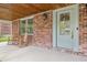 Inviting front porch with brick, windows, seating and views to the lawn at 10429 Lasalle Rd, Carmel, IN 46033