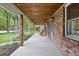 Inviting front porch with brick, windows, seating and views to the lawn at 10429 Lasalle Rd, Carmel, IN 46033