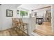 Bright eat-in kitchen with breakfast bar, wood floors, stainless appliances, and open concept layout at 10429 Lasalle Rd, Carmel, IN 46033