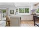 Open kitchen featuring an island, wooden floors, modern appliances, and a sliding glass door at 10429 Lasalle Rd, Carmel, IN 46033