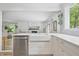 Bright kitchen with stainless appliances, farmhouse sink, and quartz countertops at 10429 Lasalle Rd, Carmel, IN 46033
