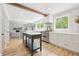 Bright, open kitchen featuring white cabinets, wood floors, stainless appliances, and eat-in island at 10429 Lasalle Rd, Carmel, IN 46033
