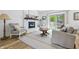 Bright living room with fireplace, wood floors, large windows and access to the back yard at 10429 Lasalle Rd, Carmel, IN 46033