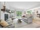 Bright living room with fireplace, wood floors, large windows and access to the back yard at 10429 Lasalle Rd, Carmel, IN 46033