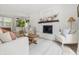 Bright living room with white brick fireplace, wood mantel, and built-in shelving at 10429 Lasalle Rd, Carmel, IN 46033