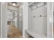 Mud room with coat hooks, bench, and view into the kitchen and hallway at 10429 Lasalle Rd, Carmel, IN 46033