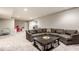 Finished basement area featuring carpet, dark gray sofa, and a black wood coffee table at 1050 Windsor Estates Ct, Westfield, IN 46074