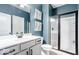 Stylish bathroom with blue walls, a modern vanity, and a glass-enclosed shower at 1050 Windsor Estates Ct, Westfield, IN 46074