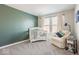 Charming bedroom with a modern accent wall, crib, and reading chair at 1050 Windsor Estates Ct, Westfield, IN 46074