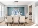 Elegant dining room with stylish chandelier, ample seating, and serene blue accents at 1050 Windsor Estates Ct, Westfield, IN 46074