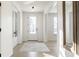 Bright entryway featuring light hardwood floors, a glass-paneled front door, and neutral decor at 1050 Windsor Estates Ct, Westfield, IN 46074