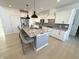 Bright, modern kitchen features an island with seating, granite countertops, and stainless steel appliances at 1050 Windsor Estates Ct, Westfield, IN 46074
