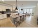 Well-lit kitchen features an island with seating, granite countertops, and stainless steel appliances at 1050 Windsor Estates Ct, Westfield, IN 46074
