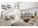 Open-concept living room with modern staircase and furniture flowing into the kitchen at 1050 Windsor Estates Ct, Westfield, IN 46074