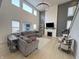 Spacious living room with soaring ceilings, fireplace, large windows, and comfortable sectional seating at 1050 Windsor Estates Ct, Westfield, IN 46074