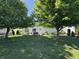 Grassy backyard featuring mature trees, offering a serene outdoor space at 11163 Autumn Harvest Dr, Fishers, IN 46038