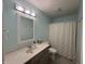 A calming bathroom is illuminated with a three-light fixture above a vanity with a modern sink at 11163 Autumn Harvest Dr, Fishers, IN 46038