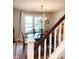 This dining room features a wood table, six chairs, beautiful rug, and staircase at 11163 Autumn Harvest Dr, Fishers, IN 46038
