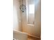 This hallway provides a bright window, unique light fixture, and stairs to the main floor at 11163 Autumn Harvest Dr, Fishers, IN 46038