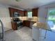 Well-lit kitchen with stainless steel appliances, wooden cabinets, and updated countertops at 11163 Autumn Harvest Dr, Fishers, IN 46038