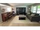 This living room offers hardwood floors, a decorative piano, and a gray sectional at 11163 Autumn Harvest Dr, Fishers, IN 46038