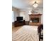 Cozy living room with a brick fireplace, chandelier, and decorative accents at 11163 Autumn Harvest Dr, Fishers, IN 46038