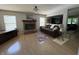 This living room showcases a fireplace, hardwood floors, stylish decor, and gray walls at 11163 Autumn Harvest Dr, Fishers, IN 46038