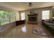 Spacious living room offers brick fireplace, hardwood floors, and a gray sofa at 11163 Autumn Harvest Dr, Fishers, IN 46038
