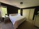 Main bedroom featuring dark accent wall, carpet, and white closet doors at 11163 Autumn Harvest Dr, Fishers, IN 46038