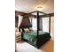This main bedroom offers a four poster bed, bedside table and soft, neutral carpet at 11163 Autumn Harvest Dr, Fishers, IN 46038