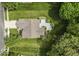 Aerial view of house with deck and driveway, surrounded by green grass and many trees at 1119 Albemarle Cir, Noblesville, IN 46062