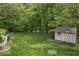 A well-kept backyard with a shed, grassy area, and a fire pit space at 1119 Albemarle Cir, Noblesville, IN 46062