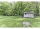 Backyard with a shed with white siding, gray roof, and double doors with an 'X' design at 1119 Albemarle Cir, Noblesville, IN 46062