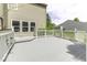 A spacious gray deck with white railings offers a serene view of the well-manicured backyard at 1119 Albemarle Cir, Noblesville, IN 46062