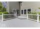 A spacious gray deck with white railings offers a serene view of the well-manicured backyard at 1119 Albemarle Cir, Noblesville, IN 46062