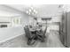 A dining room features a modern table and chairs, with a view to a modern kitchen at 1119 Albemarle Cir, Noblesville, IN 46062