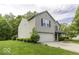 Well-maintained two-story home featuring an attached garage and a lush green lawn at 1119 Albemarle Cir, Noblesville, IN 46062